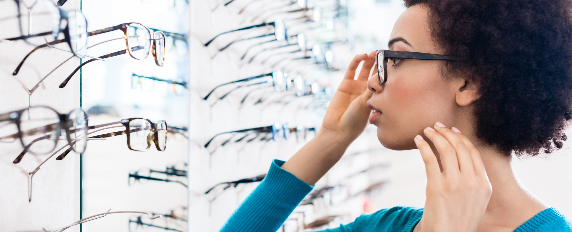 Woman trying on glasses in an opticians